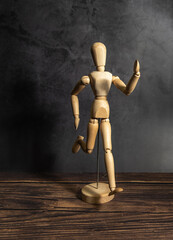 wooden mannequin,wtih running pose, dark background