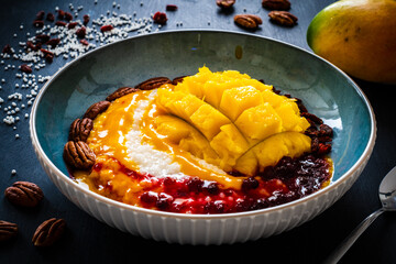 Mango and tapioca dessert on black wooden table