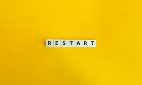 Restart Word on Letter Tiles on Yellow Background. Minimal Aesthetics.