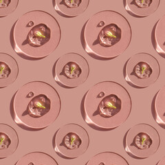 A drop of cosmetic gel with a flower on a pink background.
