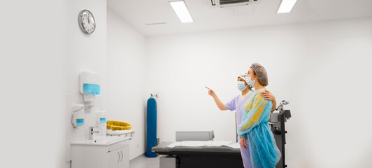 Female patient and her doctor looking at a watch as a post-operative procedure for the diopter laser removal