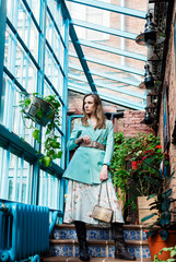 attractive slim young woman posing on stairs steps