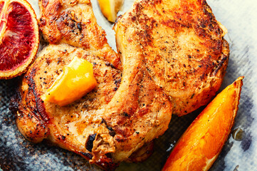 Barbecue meat steak with citrus fruits.