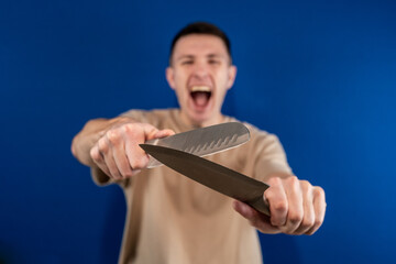 a young man with knives on a blue background