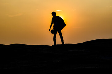 silhouette of a person on the top of mountain