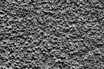 Asphalt road close up image in black and white. Asphalt background in black and white.