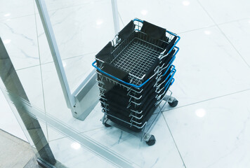 Empty shopping carts or backets on boutique floor. Selective focus.