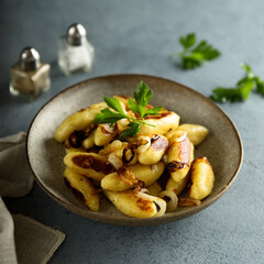 Traditional German potato dumplings with fried onion