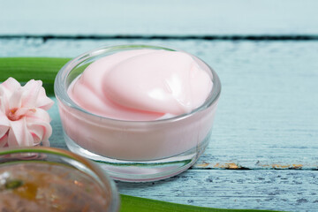 cosmetic creams with pink hyacinth flowers, on old cracked blue table