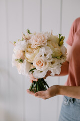 Bouquet in female hands. Rose flowers for a gift