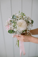 The original bouquet of flowers in the hands of women