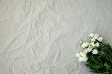 Flower arrangment on crumpled paper.