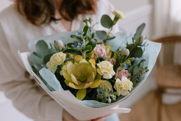 Beautiful bouquet in male hands. Unexpected gift for wife