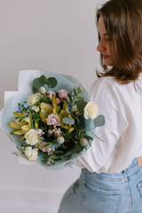 The original bouquet of flowers in the hands of women