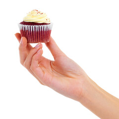 Frosty goodness. Closeup studio shot of a woman holding up a cupcake isolated on white.