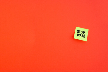 Stop war. Note on red background. Please stop the war 