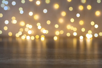 Blurred christmas lights with reflection on empty brown wooden table background for product presentation