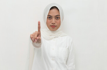 young muslim woman with open hand doing stop sign with serious expression defense gesture isolated on white background