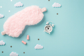 Top view photo of the cozy fluffy pink blindfold little white clock with two pink earplugs and a confetti in shape of little stars and clouds on the isolated pastel blue background copyspace