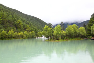 Naklejka na ściany i meble Baishui River in Yulong Naxi Autonomous County, Lijiang City, Yunnan Province, also known as Blue Moon Valley