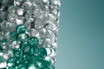 Hydrogel balls in a glass vase. Hydrogel as an art object or background for a computer desktop. Hydrogel close-up.