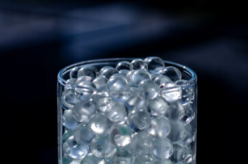 Hydrogel balls in a glass vase. Hydrogel as an art object or background for a computer desktop. Hydrogel close-up.