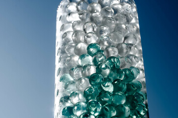 Hydrogel balls in a glass vase. Hydrogel as an art object or background for a computer desktop. Hydrogel close-up.