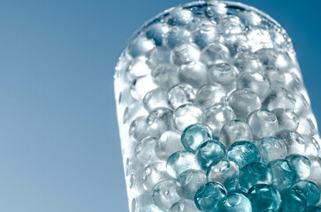 Hydrogel balls in a glass vase. Hydrogel as an art object or background for a computer desktop. Hydrogel close-up.