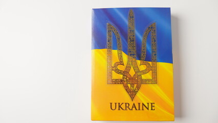 Ukraine flag and coat of arms. Golden trident on cloth flag. National symbol. Blue-yellow flag of Ukraine.