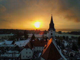 Church at sunset in winter, photographed by a drone