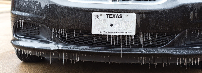 Panorama view frozen Texas license number with icicles. Icy frosty cover Black SUV car bumper, plate number in severe winter storm - obrazy, fototapety, plakaty