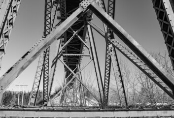 Railway bridge over calm river in winter in Quebec, Canada