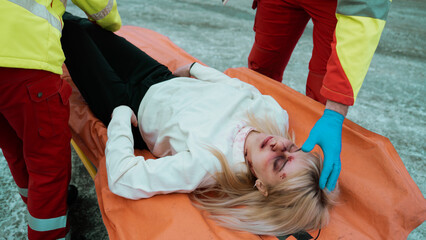 Unconscious Young Caucasian Female Laying on a Stretcher After Suffering a Bad Injury on Her Face...