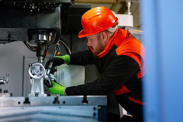 Mechanical technician operative of cnc milling cutting machine center at tool workshop