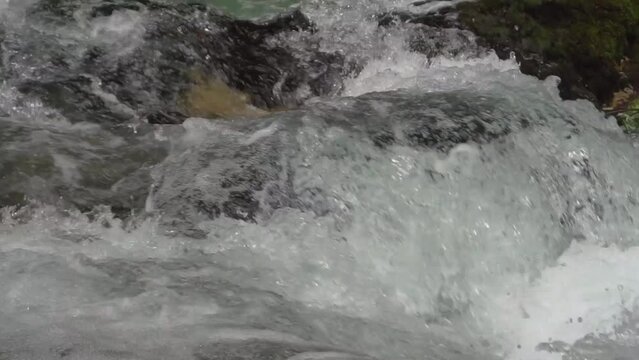 Closeup landscape beautiful following wavy water in Soteska Vintgar, Slovenia