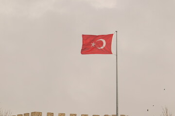 Erzurum in Turkey 02.25.2022.
Turkish flag flutters in the wind over Erzurum Castle (Turkish: Erzurum Kalesi).
Turkey Erzurum travel, snowfall.
Islamic ancient building
patriotism.
Temperature -50 °C