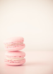 Pink macarons. Vertical photo. Delicious macaroons. Stack of two macarons on pink background.
Light background.
