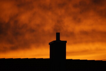 dramatic sunset over chimney