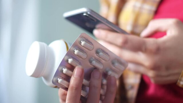 unrecognizable woman reading online medication instructions. Doctor and online consultation. Contraindications and prescription pills.