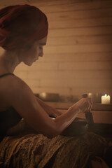A woman performs a Tibetan ritual with sound bowls. The concept of therapy