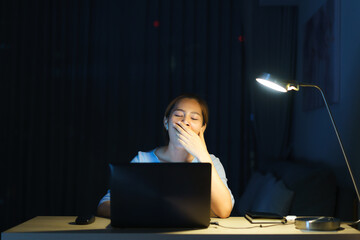 Asian woman businessman working on her laptop to prepare for the presentation tomorrow morning at...