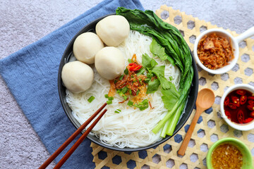 Fishballs rice noodle soup, Fishballs Bee Hoon noodle soup at top view with some sauce - Asian food 