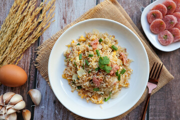 Fried rice with fermented pork and vegetables - In Thai food called Khao Pad Naem flat lay on wood table