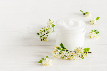 Herbal facial cream cosmetic for skin care with white flowers