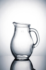 Glass jug for liquids on a white background