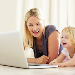 She loves watching cartoons online. Shot of a mother and daughter bonding while surfing the internet together.