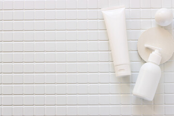 Skincare beauty cosmetic concept. White tube of cream lotion cleanser antioxidant facial oil on white background in a bathroom, copyspace