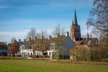 Fototapeten Dutch village Loon op Zand, view of the church tower © Milos Ruzicka/Wirestock