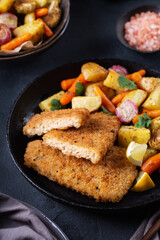 Vegan Plant based fish with crispy batter and roasted vegetables