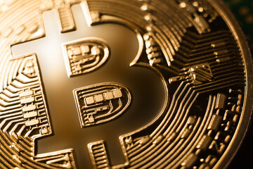 Bitcoin B logo. Macro photo of shiny gold coin symbol detail. Simple bright golden bitcoin crypto currency logo. BTC cryptocurrency, digital asset concept.